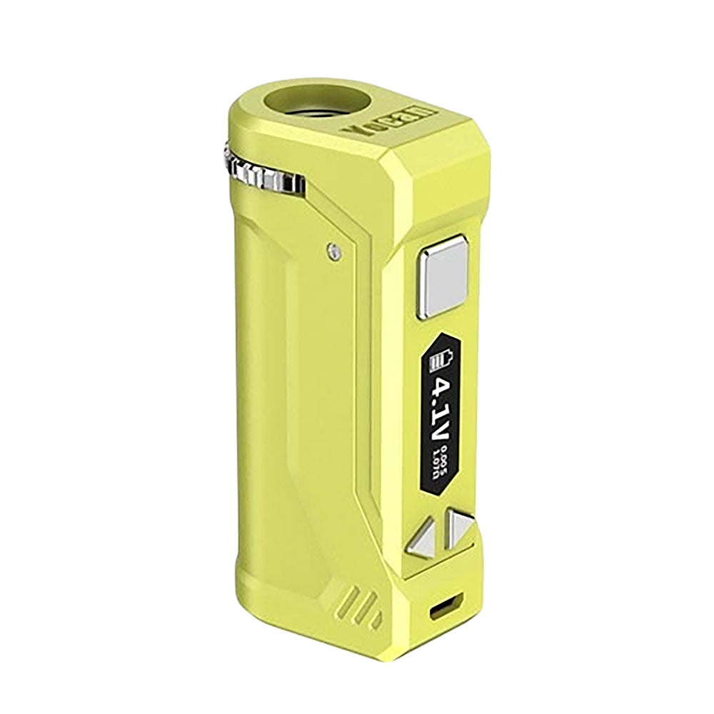 A front-facing studio shot of the Yocan UNI Pro in Apple Green. This variant features a bright, neon-green matte finish that makes the black adjustment buttons and OLED screen pop. The image highlights the device's sharp-edged, "aggressive" design and the top aperture slider for universal cartridge fit.