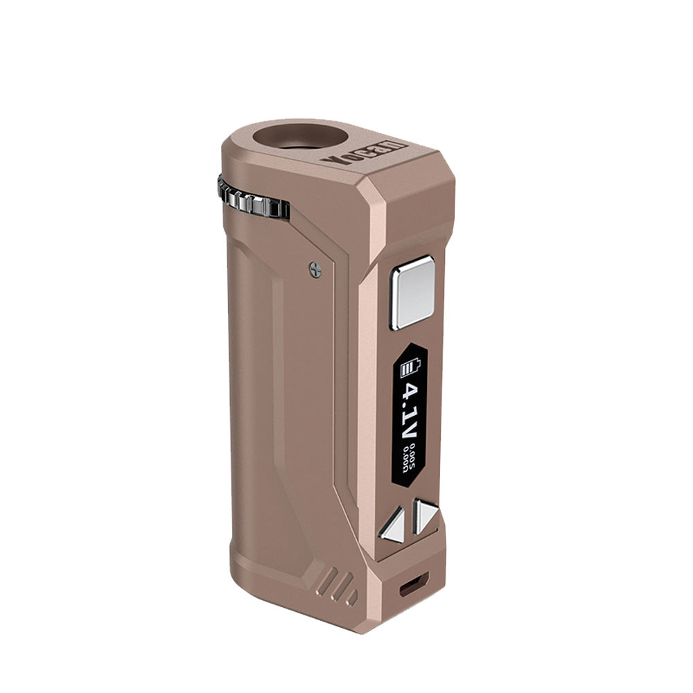 A front-profile view of the Yocan UNI Pro in Dark Champagne. This variant boasts a premium, earth-toned metallic finish with a subtle bronze-gold luster. The image showcases the unit's industrial design, including the top-mounted aperture dial and the side-aligned USB charging port.