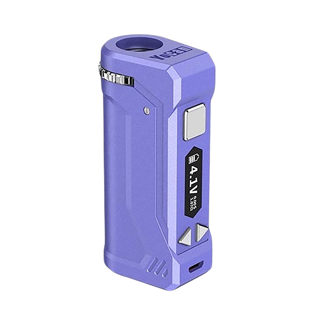 A front-facing studio shot of the Yocan UNI Pro in Purple. The device features a soft, matte lavender-purple finish that complements the silver firing button and adjustment keys. The OLED screen is active, highlighting the precision voltage interface and the iconic recessed cartridge chamber.