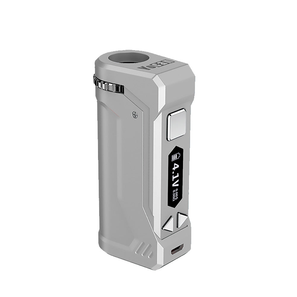 A front-profile view of the Yocan UNI Pro in Silver. The device is shown in a sleek, brushed metallic silver finish, giving it a premium and professional appearance. The OLED display is active, showcasing the 0.1V precision adjustment interface against the sophisticated, neutral-toned chassis.