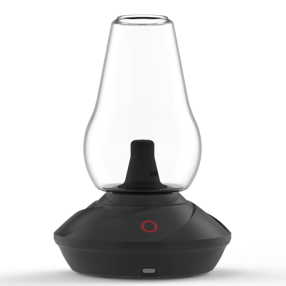 A detailed studio product shot displaying the Zenco Uno Vaporizer in the stealthy Onyx colorway. The shot focuses on the minimalist, matte black finish of the smart electronic base unit, showcasing the central touch-activation power button and the clear glass drinking cup attachment mounted securely on top.